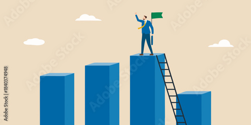 A businessman celebrates success atop a growing bar graph with a green flag