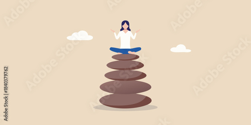 A woman meditating peacefully atop a balanced stack of stones in nature