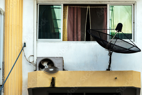 Compressor fan with broken cover. Old dirty broken condensing unit outside building. Damaged air compressor of air conditioner with dirty on wall outdoor. Broken air conditioner condenser unit outside