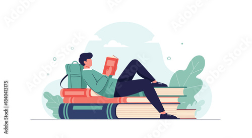 Relaxed young man lying on a large stack of books while reading, illustrating a love for literature and continuous learning.