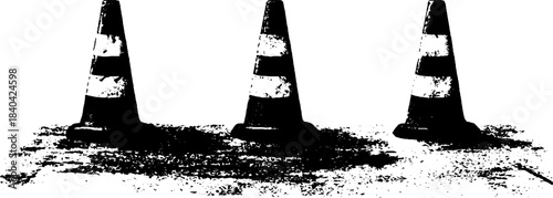 Urban street scene in black and white with traffic cones on rugged concrete
