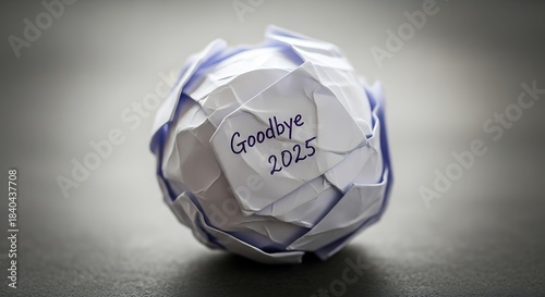 A crumpled paper ball with goodbye 2025 written on the side