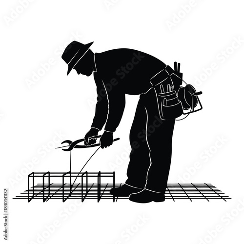 Silhouette of construction worker bending rebar with pliers on wire mesh