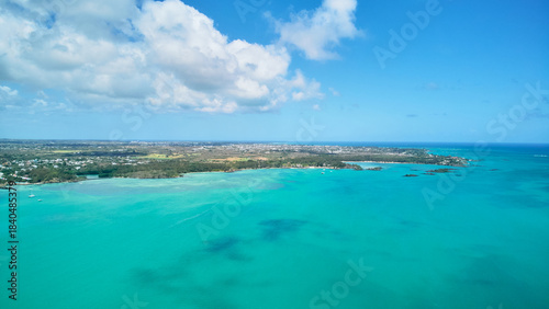 A stunning aerial view of the Mauritius landscape featuring panoramic perspectives of crystal-clear turquoise waters, tropical coastline, and lush island scenery
