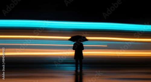 Solitary Silhouette Under Umbrella Amidst Dynamic Neon Light Trails on a Wet City Street at Night: Abstract Long Exposure Photography