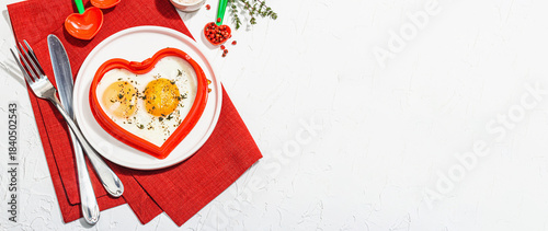 Heart-shaped fried egg served with toasted bread. Romantic art food idea for Valentine's breakfast