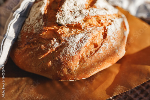Freshly baked rustic bread loaf with flour dusting