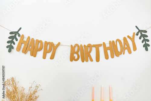 Happy birthday banner with branches and candles