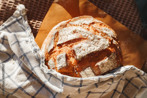 Freshly baked rustic bread wrapped in a cloth