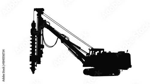 Silhouette of a large drilling rig machine against a plain white background