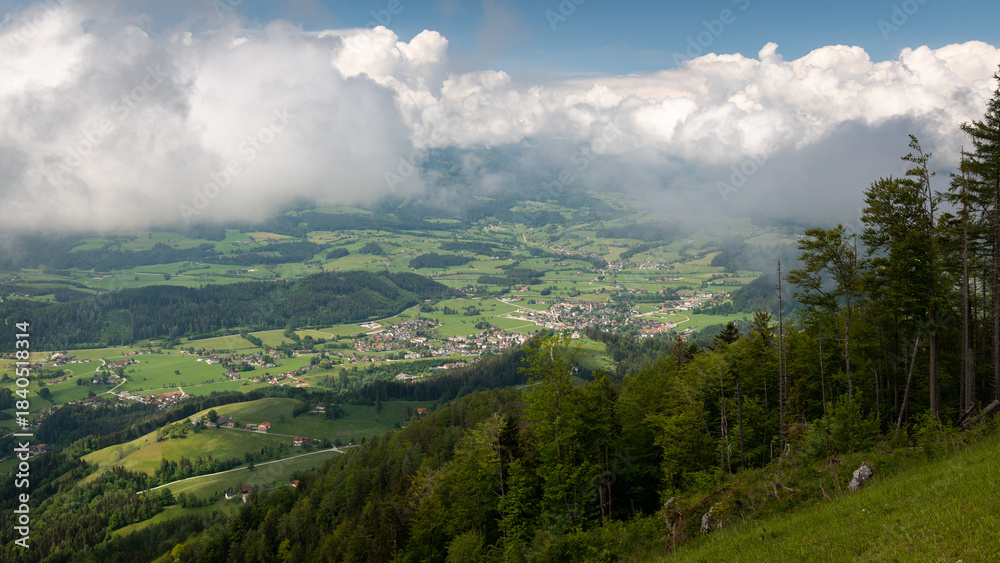 Fototapeta premium Sunny valley view with clouds above mountain horizon