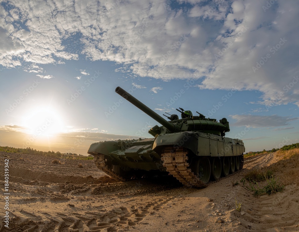 Fototapeta premium Military tank standing on a dirt road at sunset