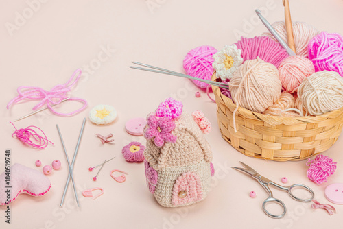 Handmade spring decor concept. Creative crocheting, house figurine, traditional flowers and hearts