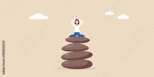 Woman meditating in lotus position atop a balanced stone tower