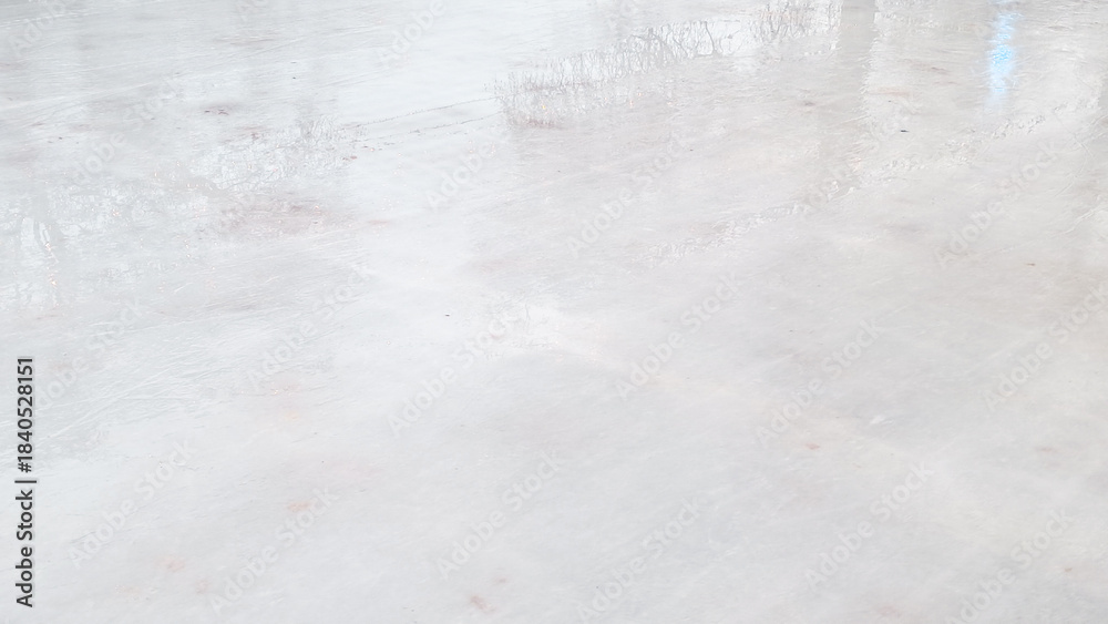 Fototapeta premium Empty winter ice rink with festive Christmas lights creating peaceful holiday mood.