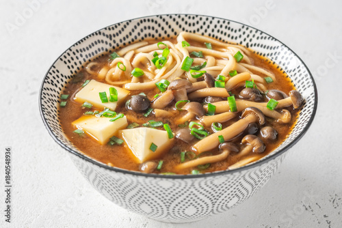 Japanese udon soup with Shimeji mushrooms, tofu, and rich dark umami broth