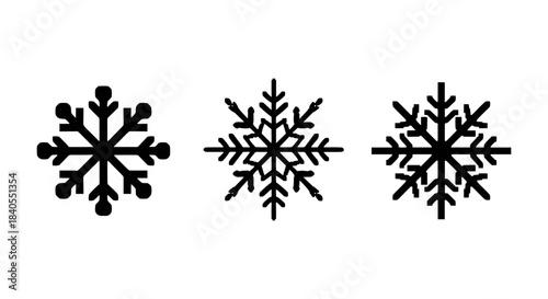 Minimalist black silhouette snowflakes on white background for seasonal design