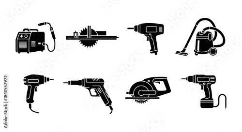 Collection of black silhouette power tools on white background