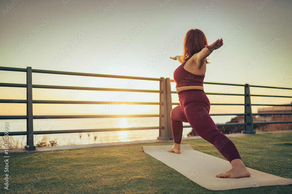 Fototapeta premium Full body yoga workout outdoors with woman in warrior position and copy space
