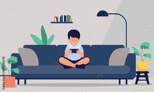 Boy child boy sitting cross-legged on a sofa, looking at his smartphone and engaging with mobile content or playing games in a cosy living room. Flat design vector illustration