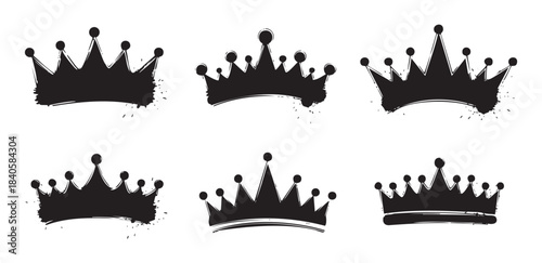 Six distinct crown silhouettes feature a grunge hand-drawn style with ink splatters, representing royalty, power, and success in a creative vector illustration.