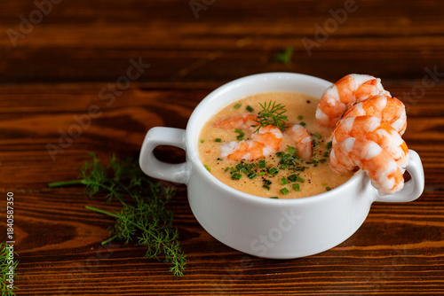 Delicious creamy shrimp bisque presented in white ceramic cup