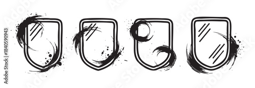 Four artistic grunge shields with brushstroke textures and distressed ink splatters creating unique graphic emblems for design projects and creative branding.