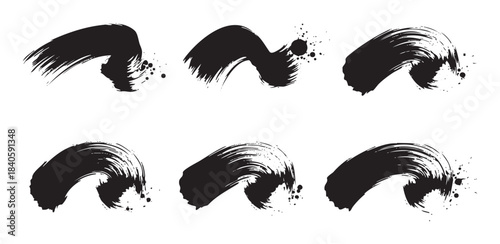 Abstract black ink brush strokes with grunge texture and expressive splatters create a dynamic artistic design element for various creative projects.