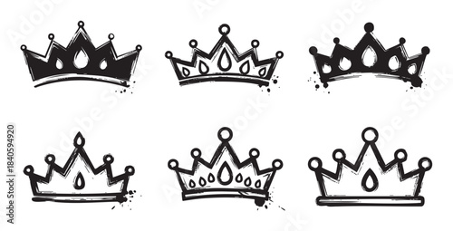 Six hand-drawn grunge crowns with various designs and textures are depicted in a collection of royal symbols, perfect for design elements.