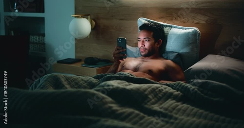 Man, phone and website in bed for temptation, self pleasure and masturbation in home. Night, secret and person with smartphone for pornography, addiction and sneaky activity in bedroom of apartment