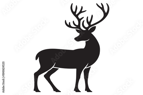 Black silhouette of a majestic stag with large antlers standing