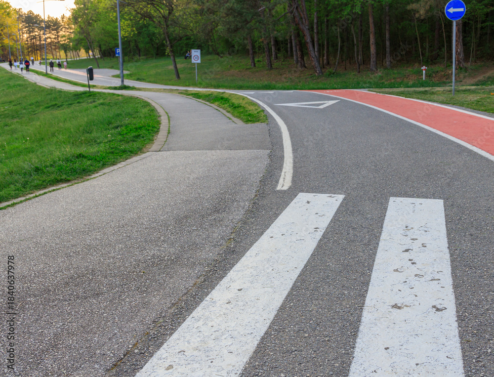 Obraz premium Road with a white line down the middle and a blue sign on the right