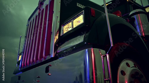Semi Truck Parked at Night Under Cloudy Sky