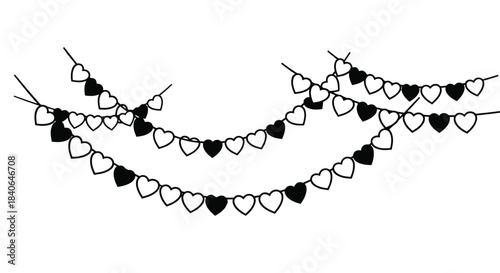 Black heart shaped garland string lights hanging against a white background