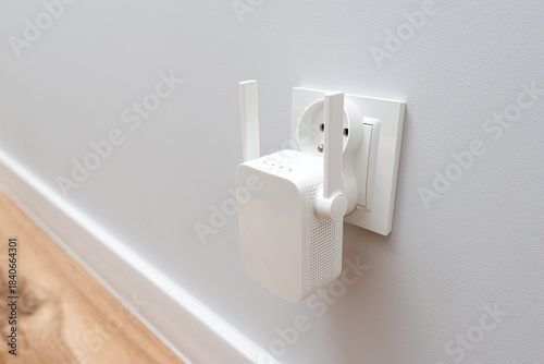 Tableau sur toile Wireless Wi-Fi repeater on white wall indoors