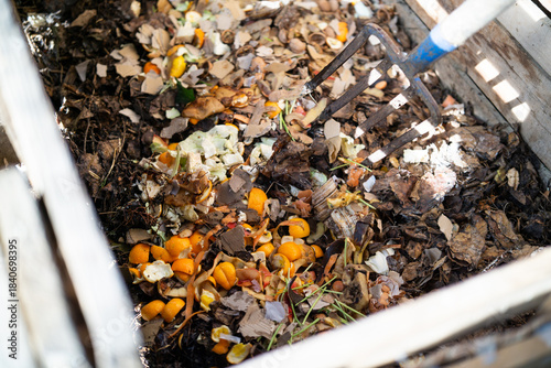 Wallpaper Mural A close-up view of a wooden compost bin filled with decomposing leaves and organic waste. Torontodigital.ca