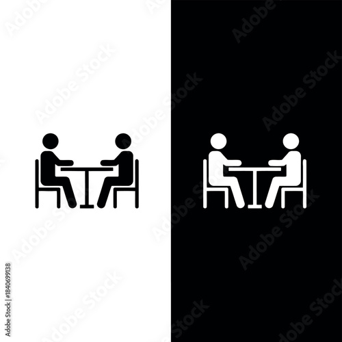 Two figures seated at a table facing each other in black and white style