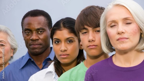 Diverse multiethnic group of men and women of different ages standing in a straight line looking at camera, symbolizing unity, inclusion and community across generations