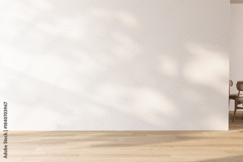 Fototapeta premium Minimalist empty room featuring a large white wall and light wood floor with natural shadows. Clean copy space for advertising and mock-ups. 3d Rendering