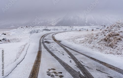 Empty frozen dangerous road after snowstorm. Icelandic mountain landscape Arnarstapi Snaefellsnes peninsula Iceland