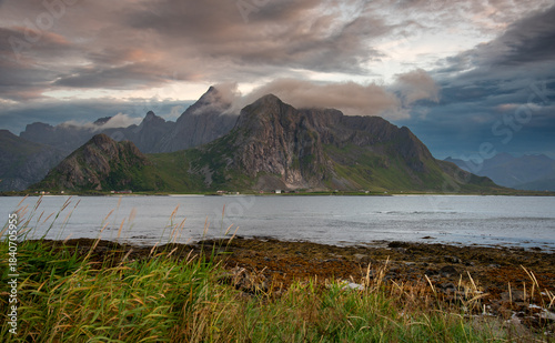 Lofoten islands landscape with fjord, mountains, and dramatic sky