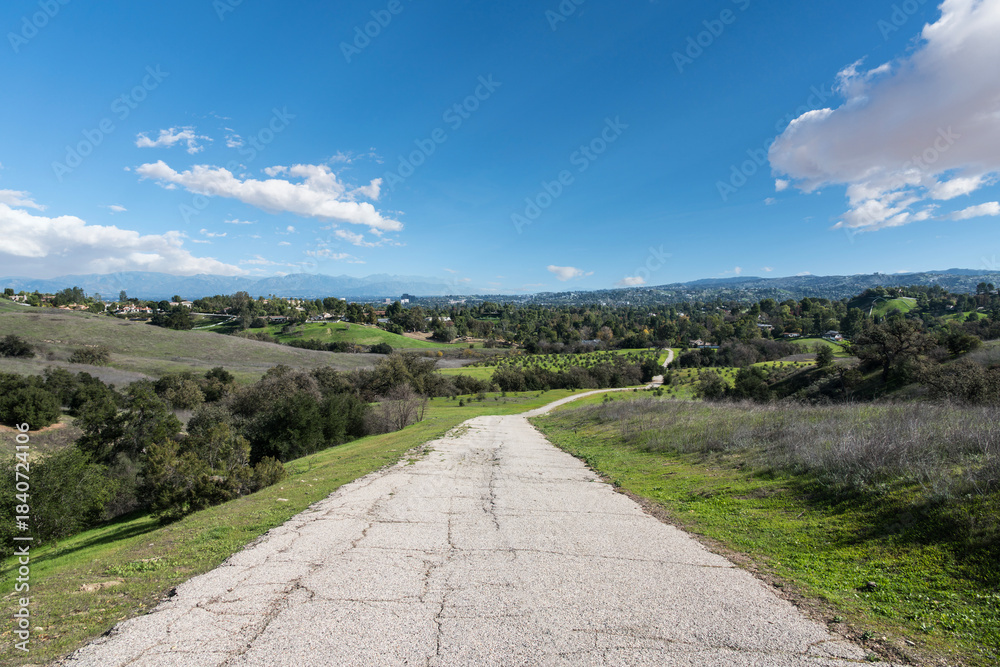 Naklejka premium Old ranch road leading to the San Fernando Valley in Los Angeles, California. Photograph taken at the Upper Las Virgenes Open Space Preserve.