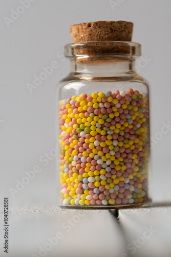 Colorful Sugar Sprinkles in a Glass Jar. Portrait format. copy space for text