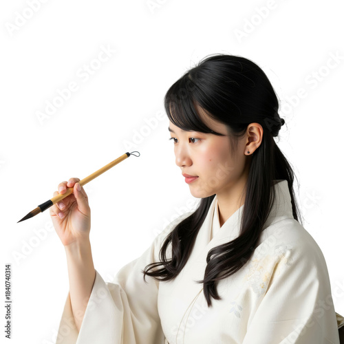 Focused young woman practices traditional calligraphy with elegance and grace