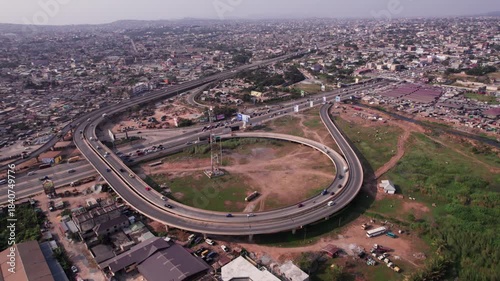 Aerial shot of N1 Highway Interchange cutting through beautiful dense urban Accra landscape