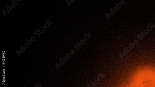 Futuristic digital orange particles flowing along an abstract cyber grid, fast 4K loop on dark background for technology and sci-fi videos.