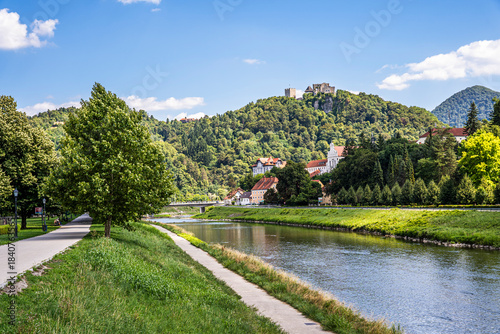 Fényképezés Waterfront of the Savinja river (Savinjsko nabrezje) with Celje Castle on the hilltop and a green urban landscape in Celje, eastern Slovenia