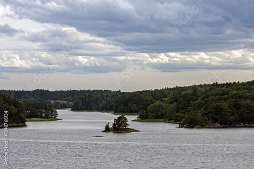 A beautiful landscape of the wide Scandinavian water area with rocky islands. A summer day on the Baltic Sea bay near Stockholm, Sweden.