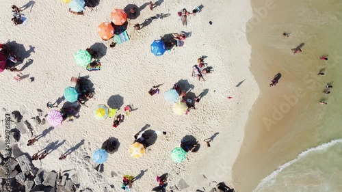 A top view of crowded sandy beach in Rio de Janeiro, Brazil. Aerial drone video.