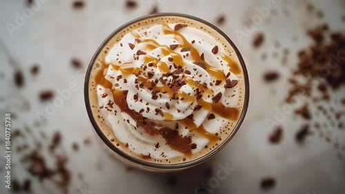 Overhead View Of A Creamy Coffee Drink Topped With Whipped Cream Caramel Drizzle And Chocolate Shavings